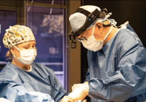 Dr. Grotting performing surgery in surgical gear
