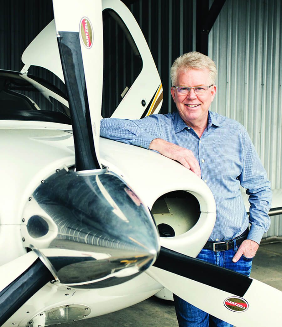 Dr. Grotting leaning on a plane
